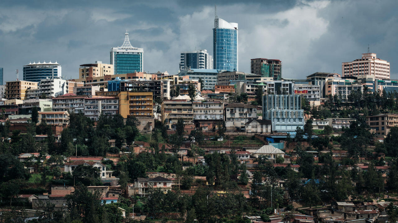 Kigali's green hills and city skyline rising under dramatic clouds